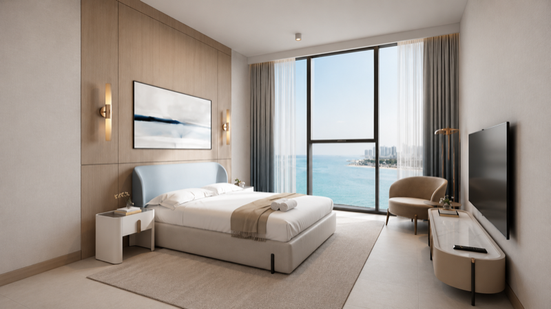 Living room of a one-bedroom residence at Alef Beachfront, Al Mamzar, with sea-facing windows